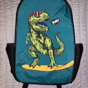 Surfing T-Rex backpack for kids with two water bottle holders and laptop pocket